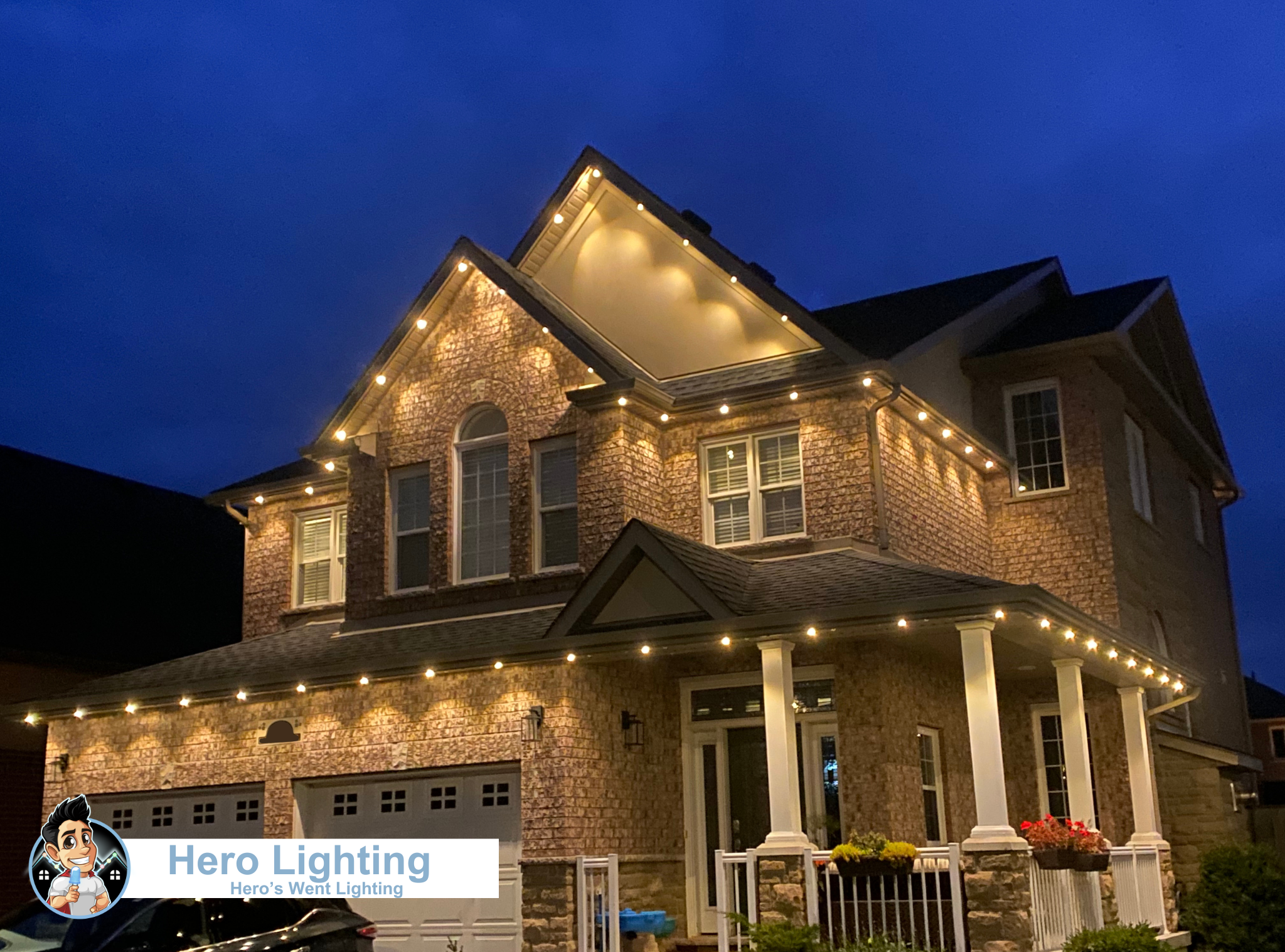 Warm white LED lights on stone home at dusk